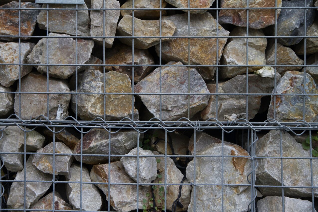 A fence of stones superimposed on a grid. Stone fence, Background with stone texture.